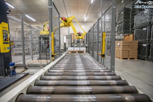 Wine packaging robot in action at Deux Roches winery Automated wine packaging robot handling boxes at Deux Roches winery.