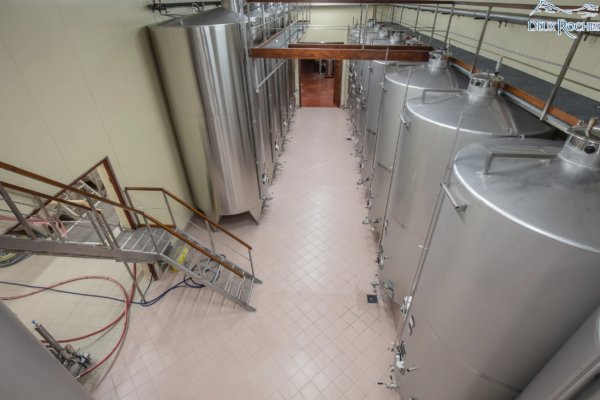 Top view of fermentation tanks at Deux Roches winery Overhead view of stainless steel wine tanks inside Deux Roches winery.