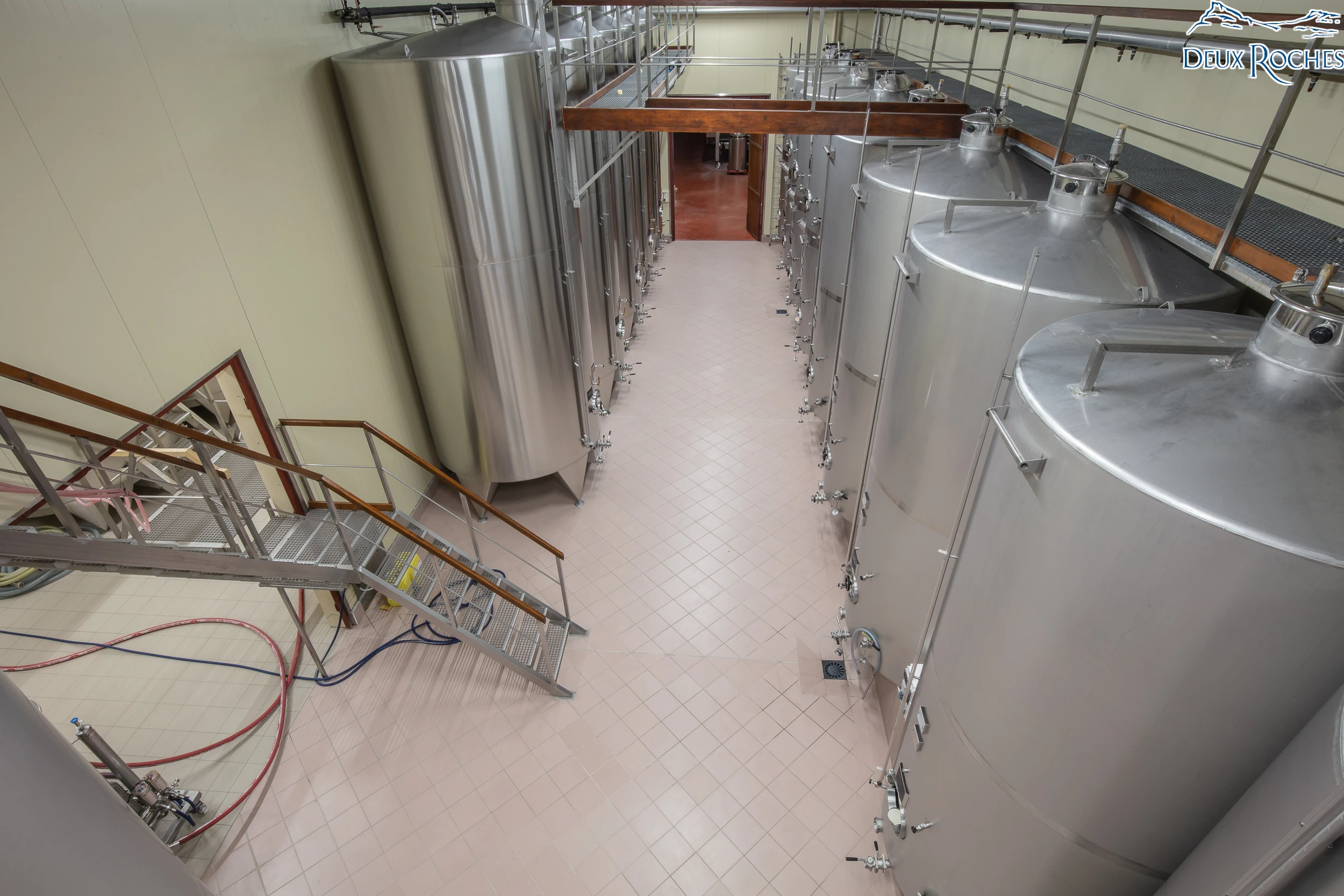 Overhead view of stainless steel wine tanks inside Deux Roches winery.