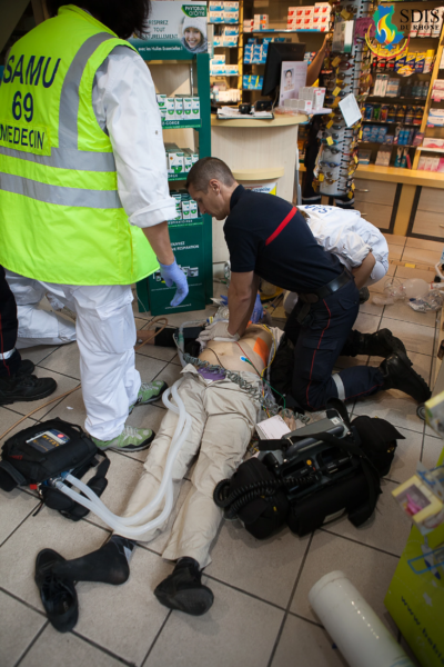 Cardiac Arrest Response in Public – Firefighter Administering CPR in a Pharmacy Emergency cardiac massage by firefighter inside pharmacy with SAMU medical team, SDIS du Rhône.