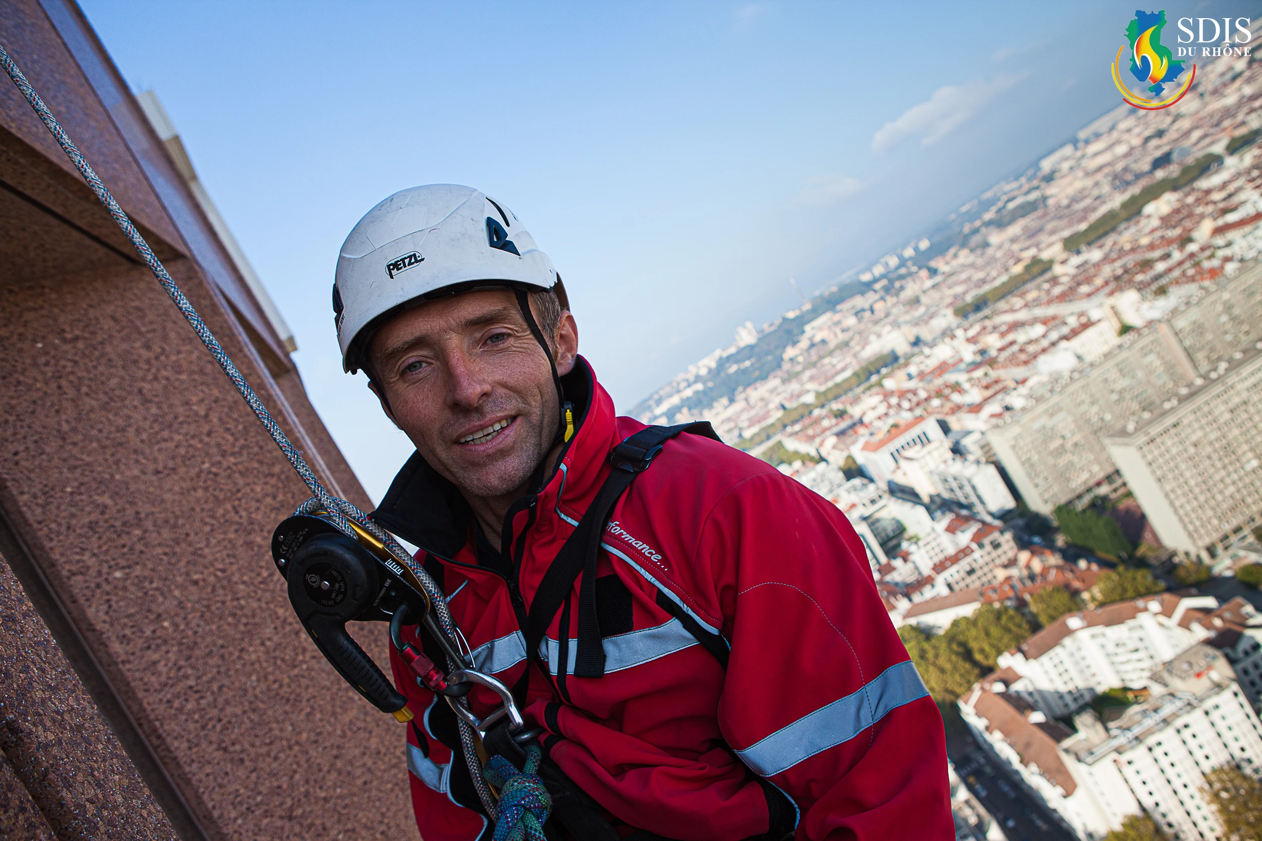Portrait of a GRIMP firefighter from SDIS du Rhône during a high-altitude training exercise on the Crédit Lyonnais Tower.