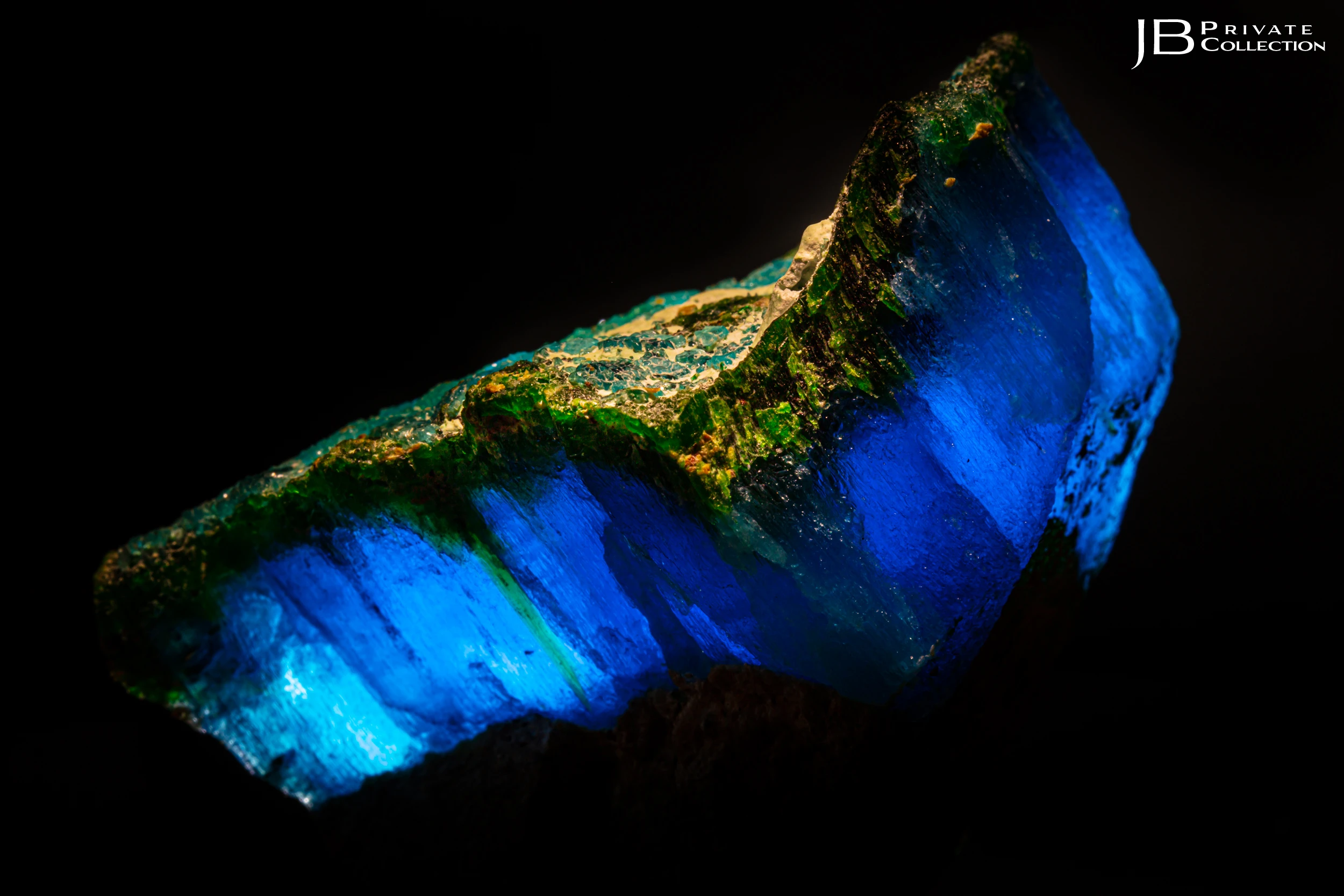 Translucent Krohnkite and Natrochalcite crystal from Chile backlit to highlight vivid blue and green hues.