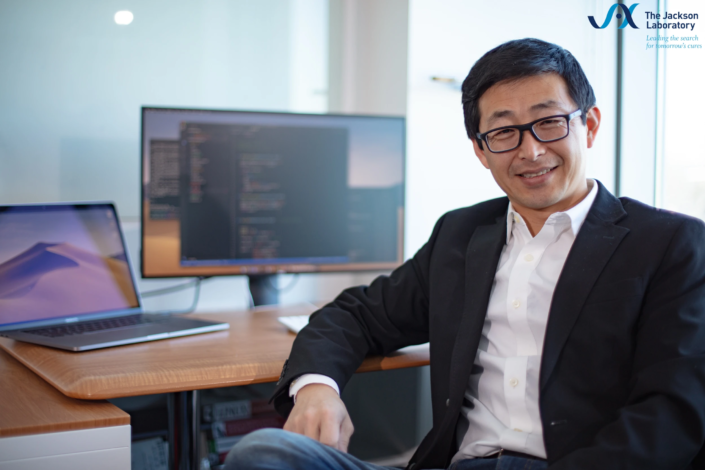 Shuzhao Li, Ph.D., Associate Professor at The Jackson Laboratory, portrait at his desk by Charles Camarda