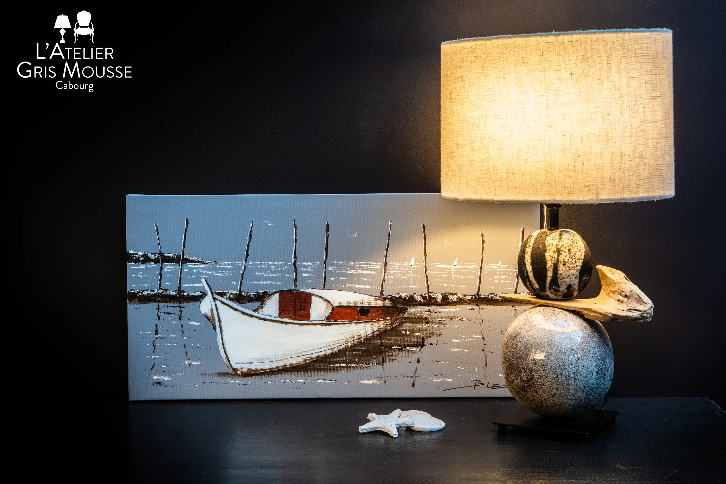 Decorative ceramic lamp and coastal painting styled in boutique – creative visual identity for interior design