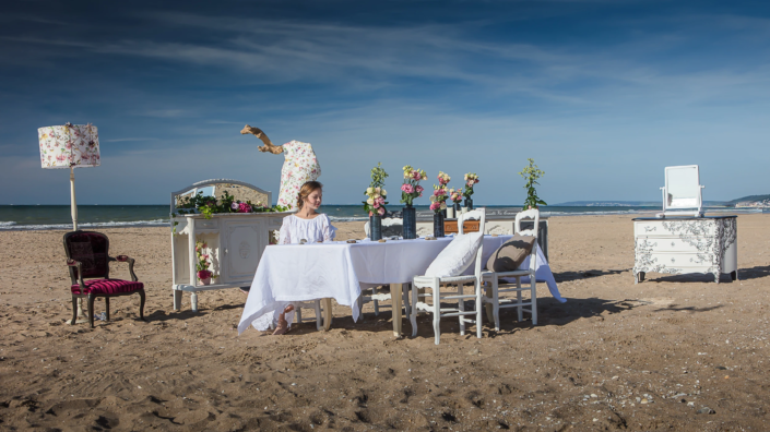 Romantic interior scene staged on the beach with patinated furniture and floral accents – Atelier Gris Mousse