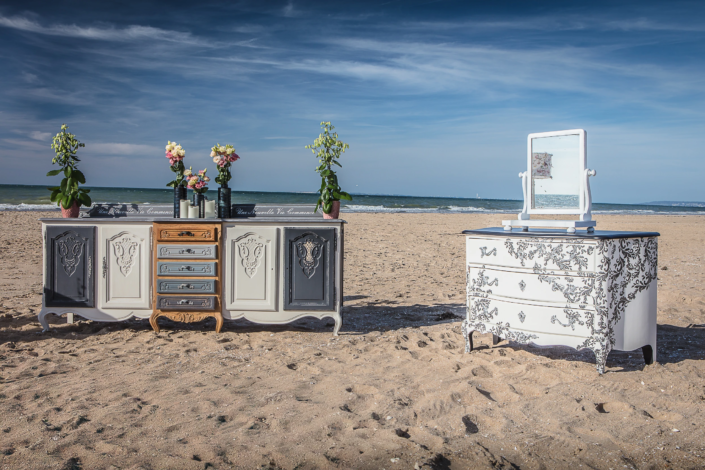 Patinated sideboard and chest of drawers displayed on the beach – Atelier Gris Mousse “Imagine Your Home” campaign