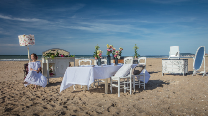 Refined beach dining scene with vintage furniture – creative visual identity for interior design