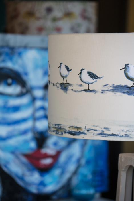 Hand-painted lampshade with bird motif and artistic backdrop – creative visual identity for interior design