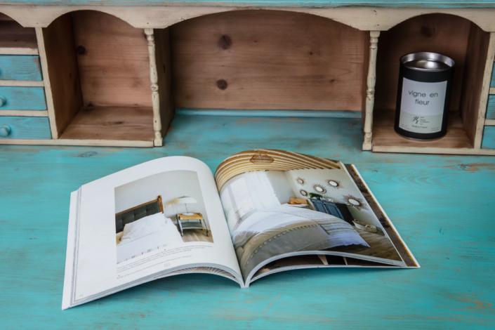Interior design magazine displayed on a turquoise patinated desk – creative visual identity for interior design