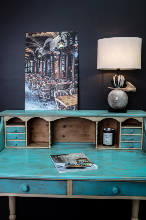 Patinated writing desk and decorative lamp styled in the boutique – creative visual identity for interior design