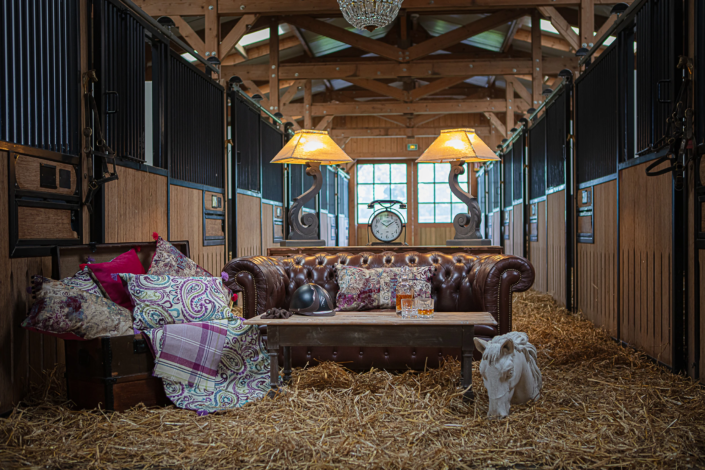 Styled living space in horse stable with restored trunk and equestrian details – Atelier Gris Mousse