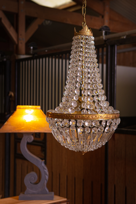 Crystal chandelier and sculptural lamp styled in an equestrian setting — creative visual identity for interior design by Atelier Gris Mousse.