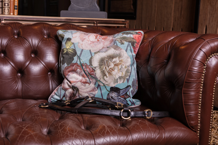 Floral cushion and vintage leather armchair – creative visual identity for interior design by Atelier Gris Mousse