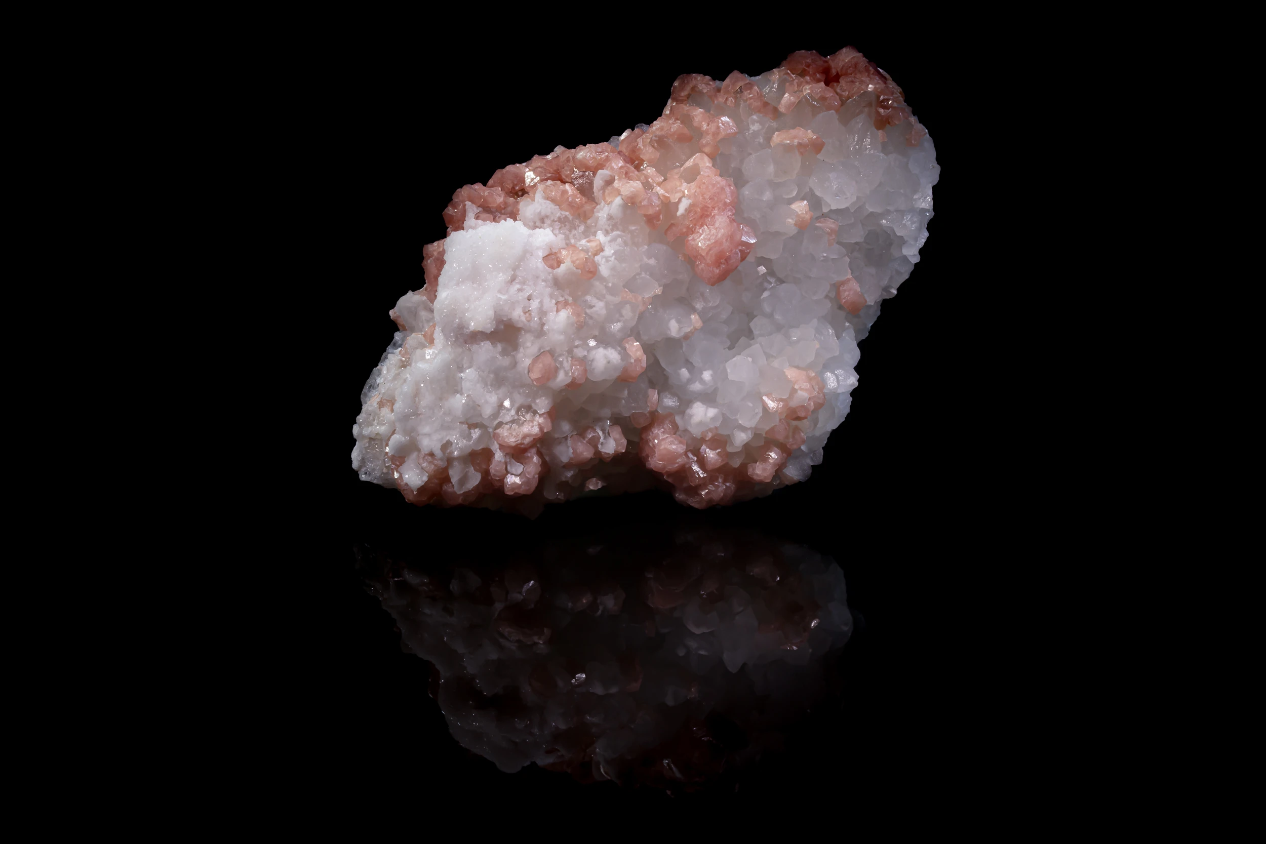 Rhodochrosite crystals on white quartz matrix from Sunnyside Mine, Colorado – reflective studio photo.