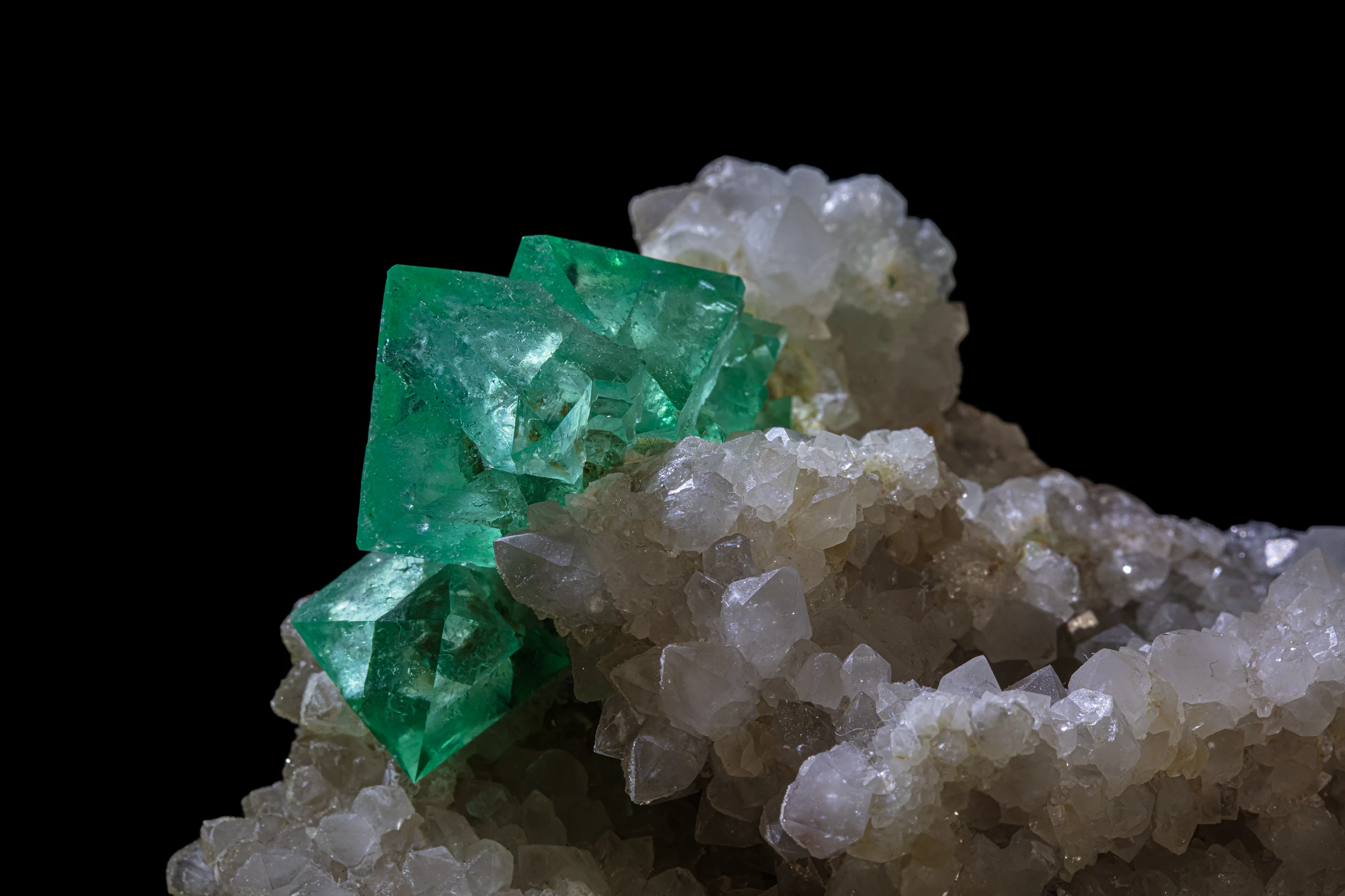 Close-up of vivid green fluorite cube on quartz crystals, from Riemvasmaak, South Africa.