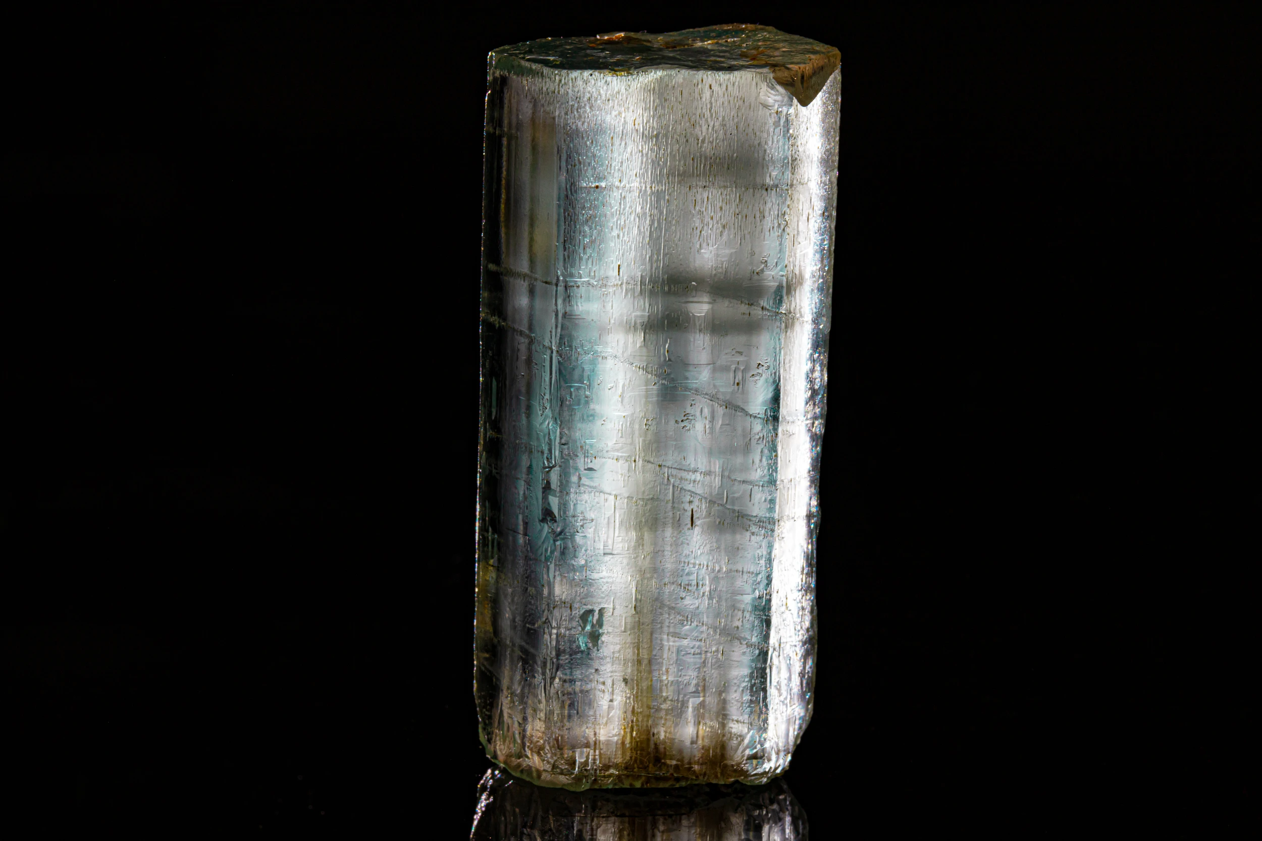 Aquamarine crystal specimen from Namibia, photographed in studio on black vinyl surface