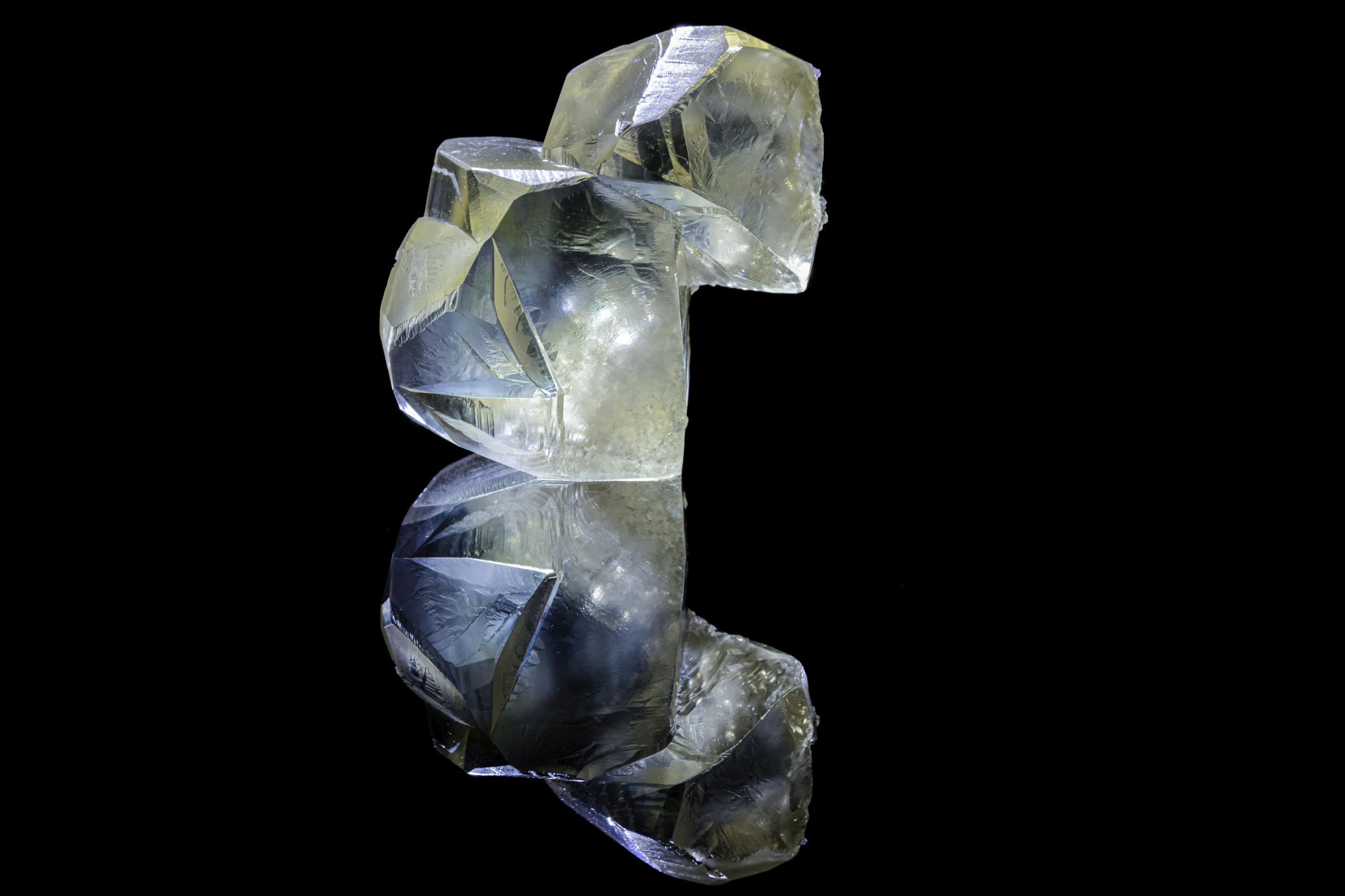 Twinned calcite crystal from Kazakhstan, photographed on black reflective vinyl