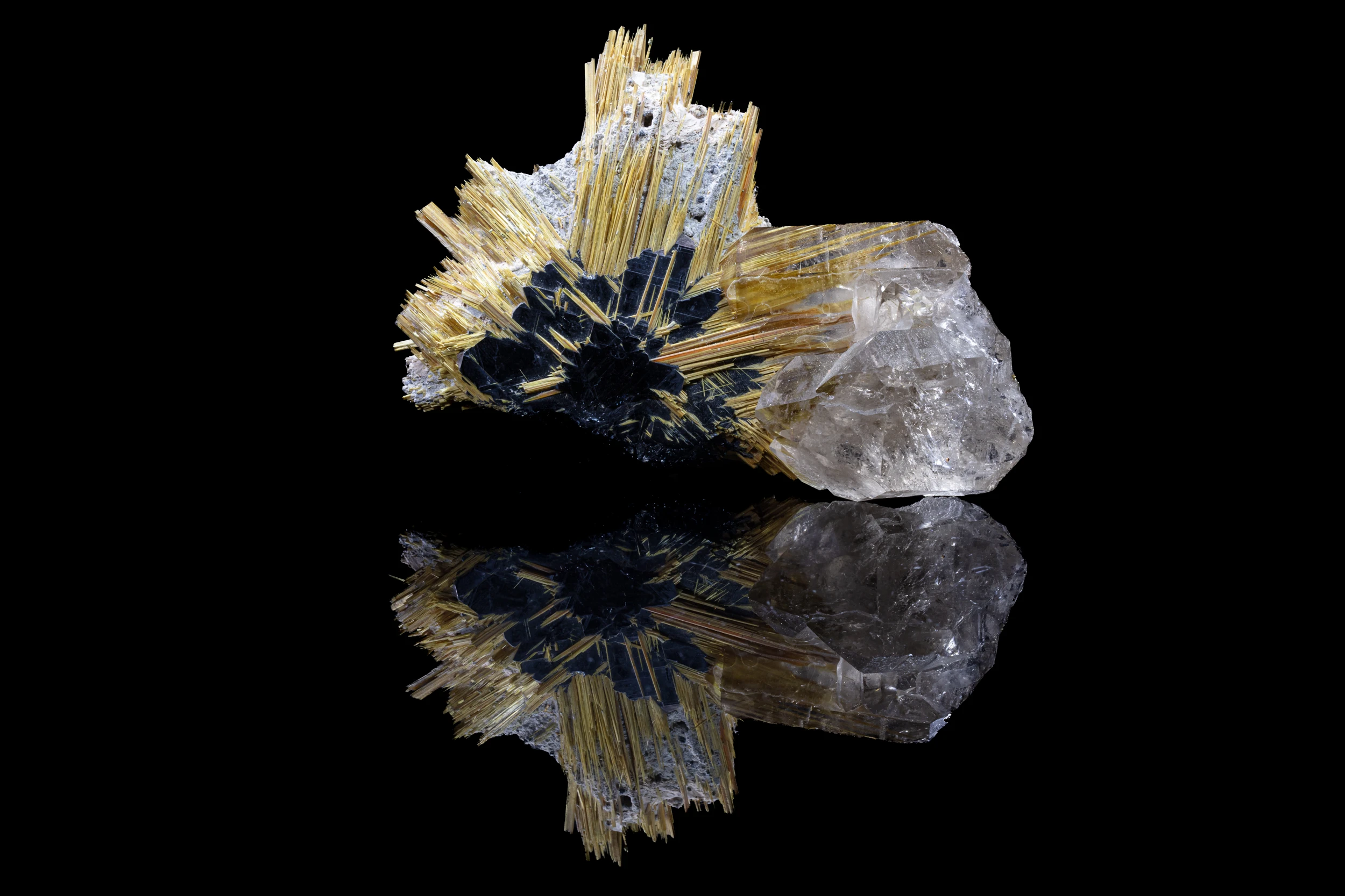 Studio photograph of Rutile on Hematite with Quartz – reflective mineral specimen on black background