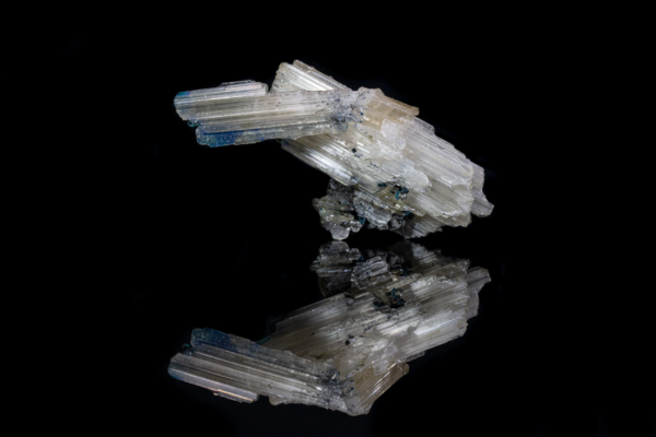 Pale bladed cerussite crystals with traces of blue-green rosasite, mirrored on black vinyl, Namibia