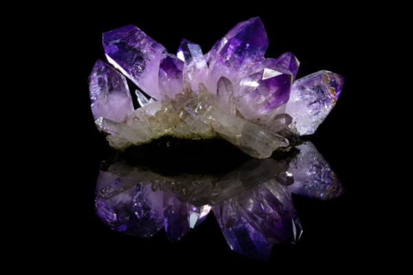 Cluster of amethyst points, deep purple at the tips fading to colorless at the base, mirrored on black vinyl, Mexico